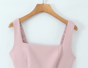 Detail of pink square neck top with ruched shoulder straps and smooth fabric texture