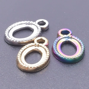 Macro shot of oval stainless steel jewelry settings in silver, gold, and rainbow finishes
