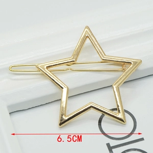 Detail view of 6.5cm gold hollow star hair clip with smooth metallic finish on frame