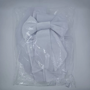 Macro detail of large white fabric bow decoration for weddings and parties in packaging