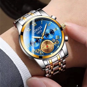 Macro shot of business quartz watch with blue sunray dial and gold stainless steel strap