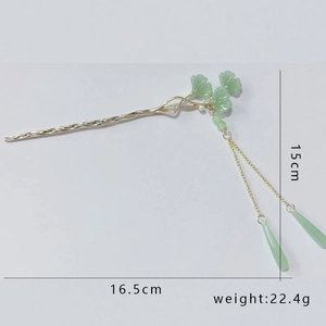 Detail view of green ginkgo leaf hairpin with golden long tassels and size dimensions