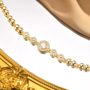 Close-up of heart-shaped zircon bracelet with gold plating and sparkling stones