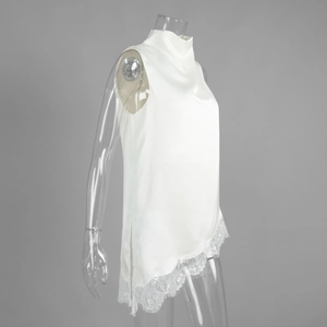 Detailed view of white high-neck satin top featuring exquisite floral lace hem and side slit