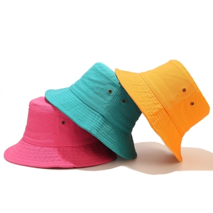Three colorful cotton bucket hats with metal eyelets in rose, green, and orange