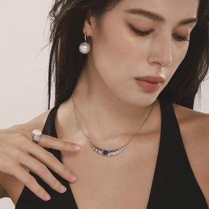 Lapis crescent moon necklace with pearl earrings and ring set on fashion model