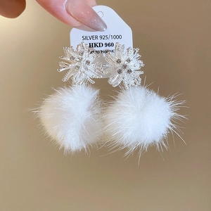 Detail of S925 sterling silver snowflake stud earrings with white faux fur pompom drop charms