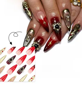 Macro detail of red and black gradient stiletto nails with golden cross and heart charms