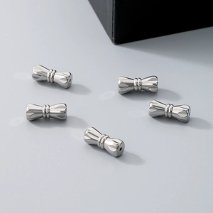 Detailed view of silver metal peanut-shaped screw clasps for jewelry necklaces