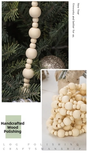 Detail of natural wooden bead garland hanging on pine branches for Christmas decor