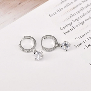 Detailed macro view of S925 sterling silver hoop earrings with clear cubic zirconia drop
