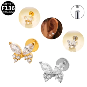 Detail of F136 titanium butterfly piercing with internal thread and white zircon stones