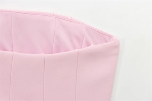 Macro detail of pink strapless top showing pleated design and high-quality stitching