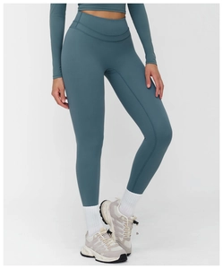 Detail shot of teal yoga set high-waisted leggings and crop top fabric texture