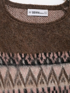 Detail shot of vintage brown knit sweater with colorful Fair Isle geometric neckline pattern