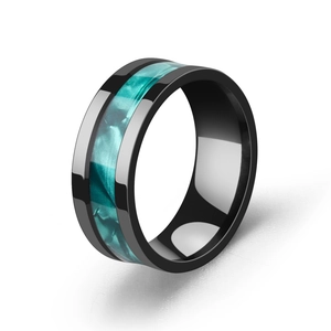 Close-up of a black stainless steel ring featuring a vibrant turquoise marble inlay detail