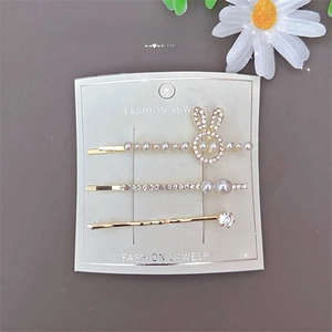 Three-piece golden rabbit hair clip set with pearls and rhinestones on card