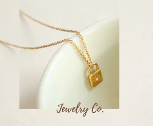 Macro detail of gold padlock pendant with starburst engraving and zircon on O-chain
