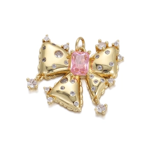 Golden bow pendant necklace with pink rectangular gemstone and clear crystals