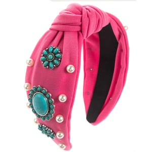 Detail of pink knotted bohemian headband with turquoise stones and faux pearls decoration