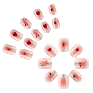 Pink heart press-on nails with silver glitter and star patterns in a full set