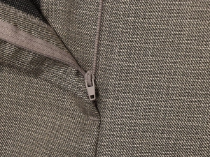 Macro shot of high-density weave texture and seamless matching zipper detail on taupe suit