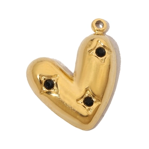Detailed macro view of heart-shaped gold pendant with three inlaid black cubic zirconia