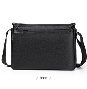 Detail view of the bag back featuring lychee grain leather and a zipper pocket