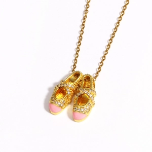 Detail of pink ballet shoe pendant with crystal accents on a gold-tone O-chain necklace