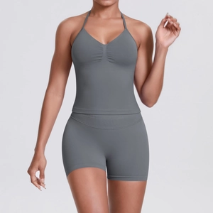 Detail of grey seamless knit yoga set featuring backless halter top and high-waist shorts