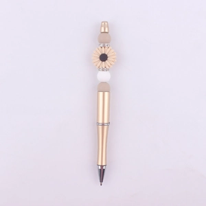 Detail of beaded pen with beige sunflower, white silicone beads and rhinestone rings