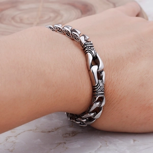 Dettaglio del bracciale a catena in acciaio inossidabile con motivi incisi vintage