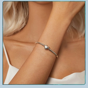 Close-up of S925 sterling silver heart pendant bracelet on a woman's wrist