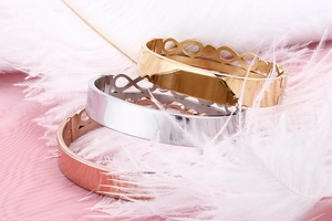 Infinity titanium steel bracelet with double-row crystals shown on white feathers