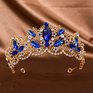 Luxury Baroque gold crown with deep blue crystals and diamonds on brown satin
