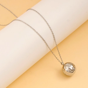 Detailed view of silver spherical pendant necklace on a minimalist display stand