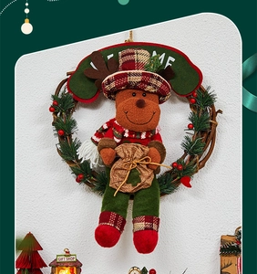 Detail of Christmas reindeer wreath with rattan base, pine needles and welcome sign