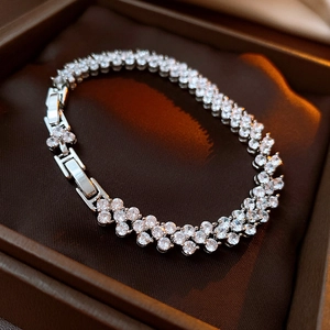 Close-up of a silver-tone multi-row zircon bracelet with a secure fold-over clasp