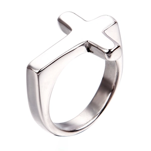 Macro side view of silver stainless steel cross ring with polished mirror finish surface