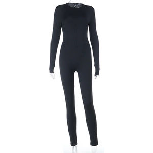 Detail view of the cinched waist and tailored fit of the black long-sleeve jumpsuit