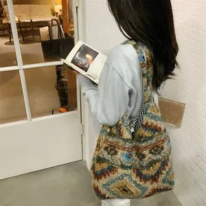 Lifestyle shot of large plush tote bag with colorful geometric patterns worn by model