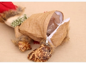 Detail view of the white zipper opening on the back of a burlap Christmas doll gift bag