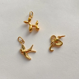 Polished 14K gold plated charms featuring balloon dog, swallow bird, and elephant designs