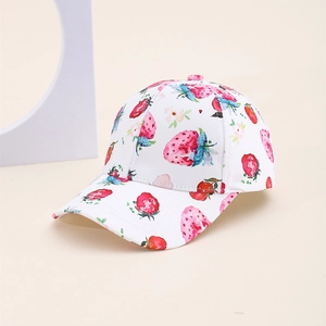 Detailed view of white cotton baseball cap with red strawberry prints and flat brim