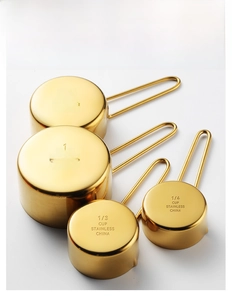 Detailed bottom scale markings on a 4-piece rose gold stainless steel measuring cup set