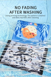 Washable baby cloth book with ocean animal illustrations submerged in water showing no fading