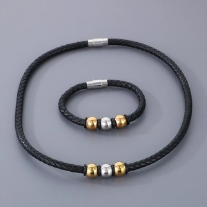 Detailed close-up of men's braided leather bracelet and necklace with magnetic clasp