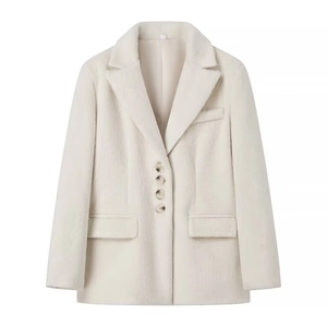 Detail of light beige faux fur coat with lapel collar, four buttons and flap pockets