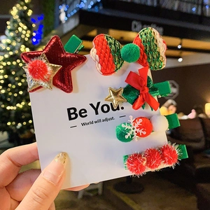 Set of 5 Christmas themed hair clips with festive bow and star designs for children