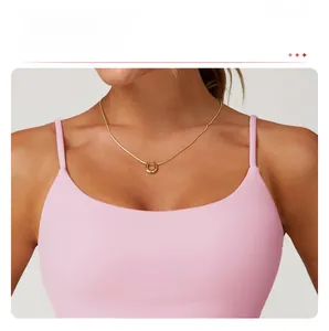 Detailed view of pink sports top with large U-neck and delicate double shoulder straps